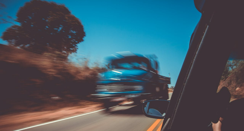 A speeding truck on the road.